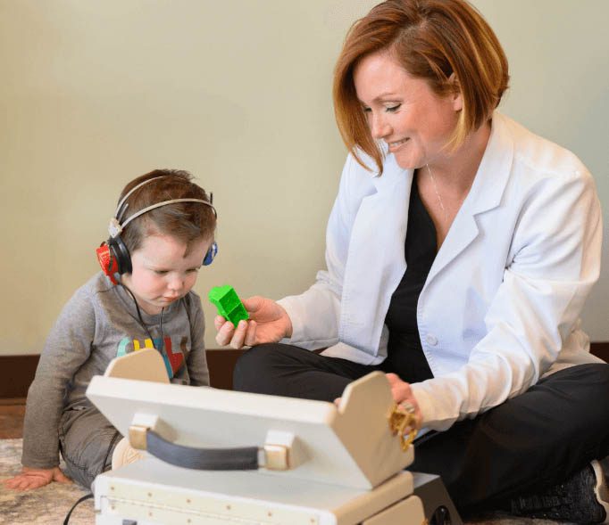 Dr. Erica Person conducting a pediatric hearing test
